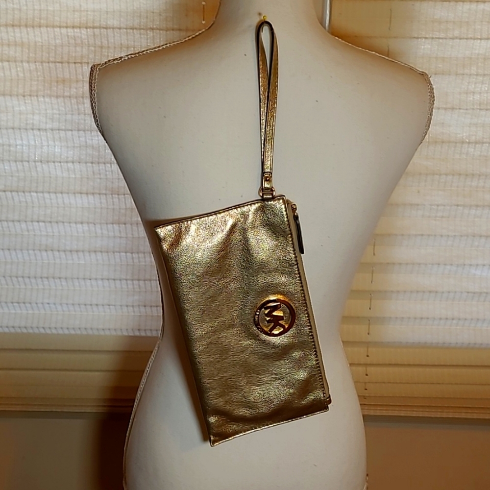 MICHAEL KORS gold wristlet.
